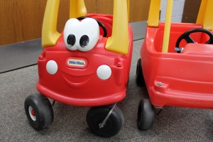 Red and yellow cars for children to ride in